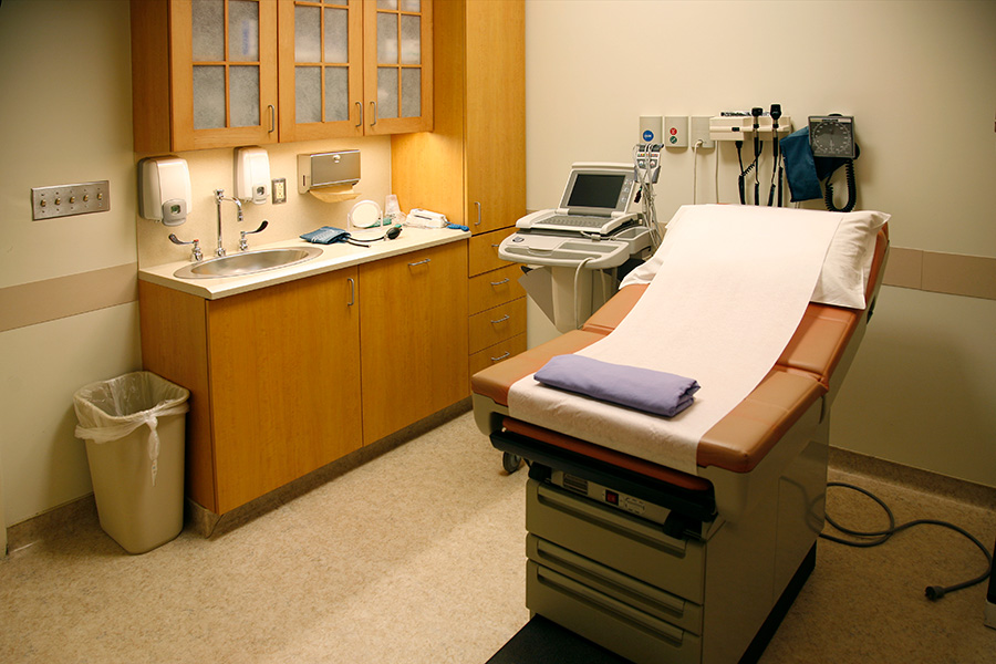 Patient examination room, sink, counter, medical supplies and patient exam table