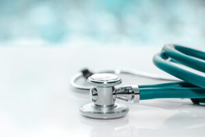 Doctor's stethoscope laying on glass table